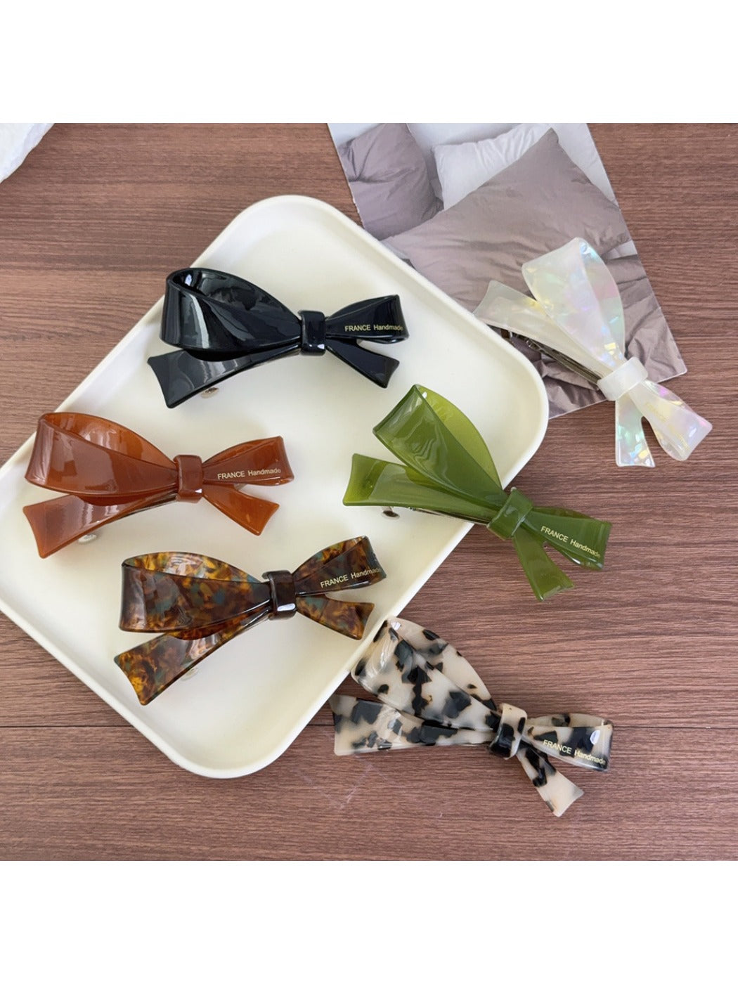 Beau acetate bow-shaped hair clip on white background, front view