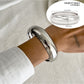 Lovra vintage polished irregular bangle bracelet angled to show polished finish