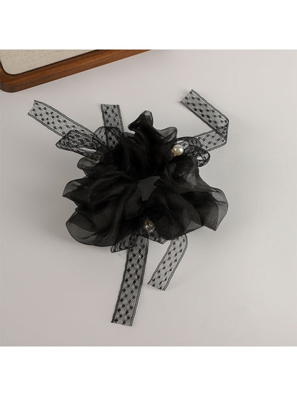 Top view of ruched scrunchie showing gathered fabric and bow detail
