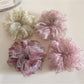 Gifty floral print hair scrunchie styled on a model's wrist with soft fabric texture visible