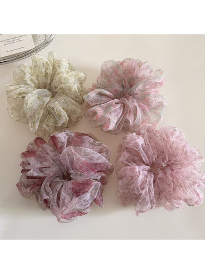 Gifty floral print hair scrunchie styled on a model's wrist with soft fabric texture visible