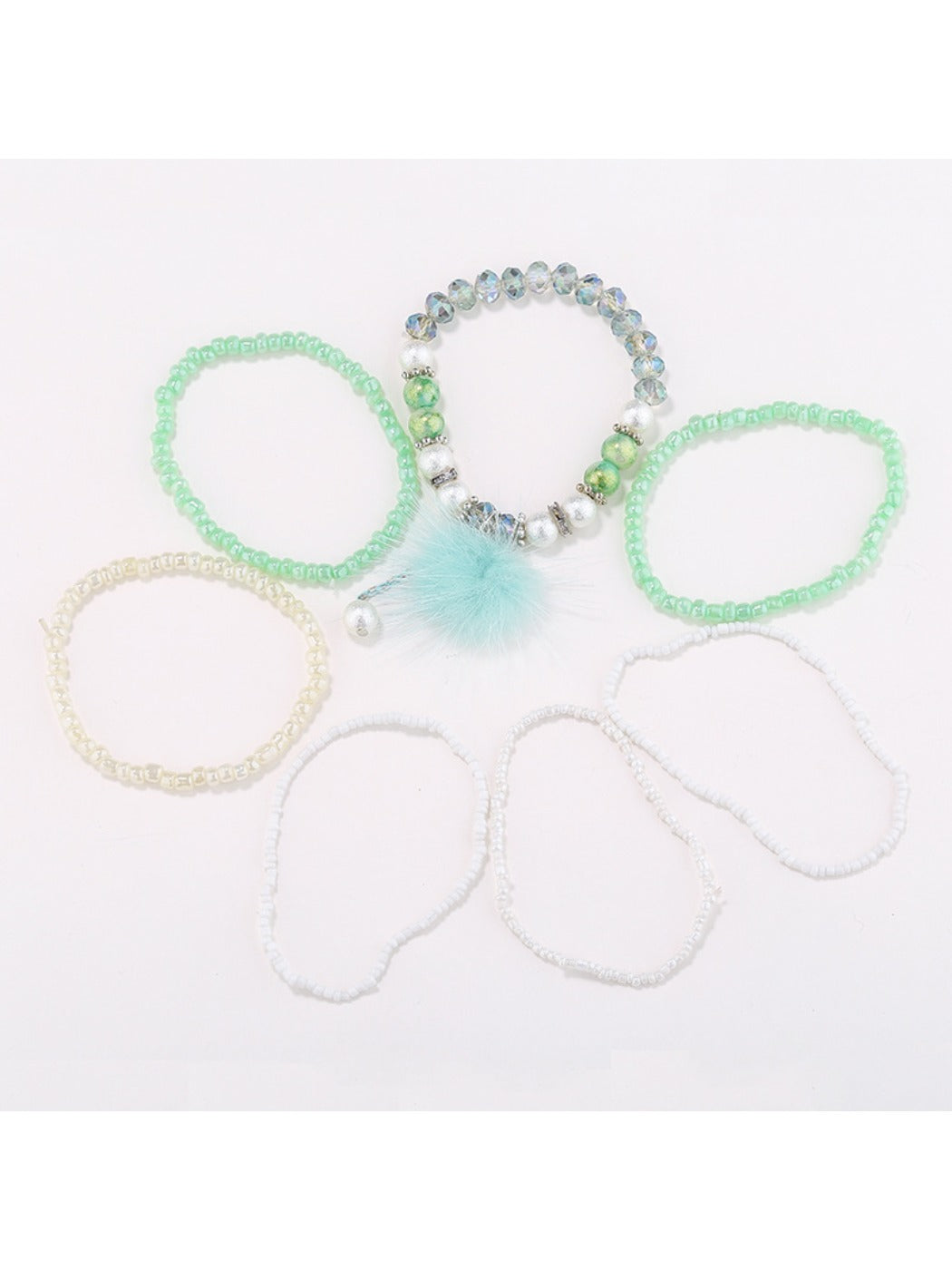 Close-up of Lovra bracelet showing detailed beaded design and pompom pendant