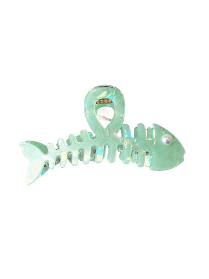 Beau fishbone acetate hair clip next to matching accessories on a table