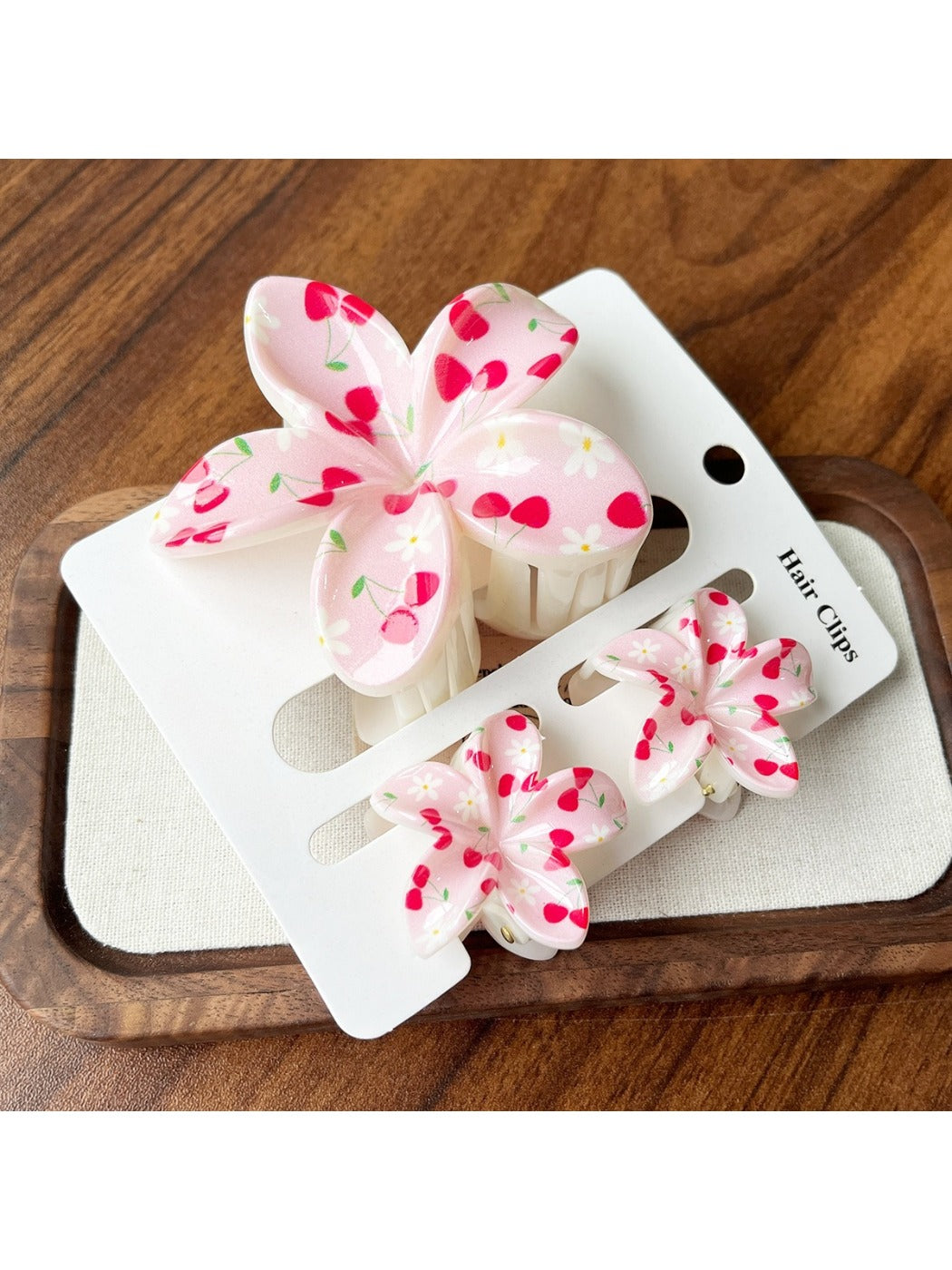 Pastel purple flower shaped claw clip on a wooden surface