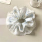 Gifty scrunchie paired with casual outfit, emphasizing its modern and minimalist style