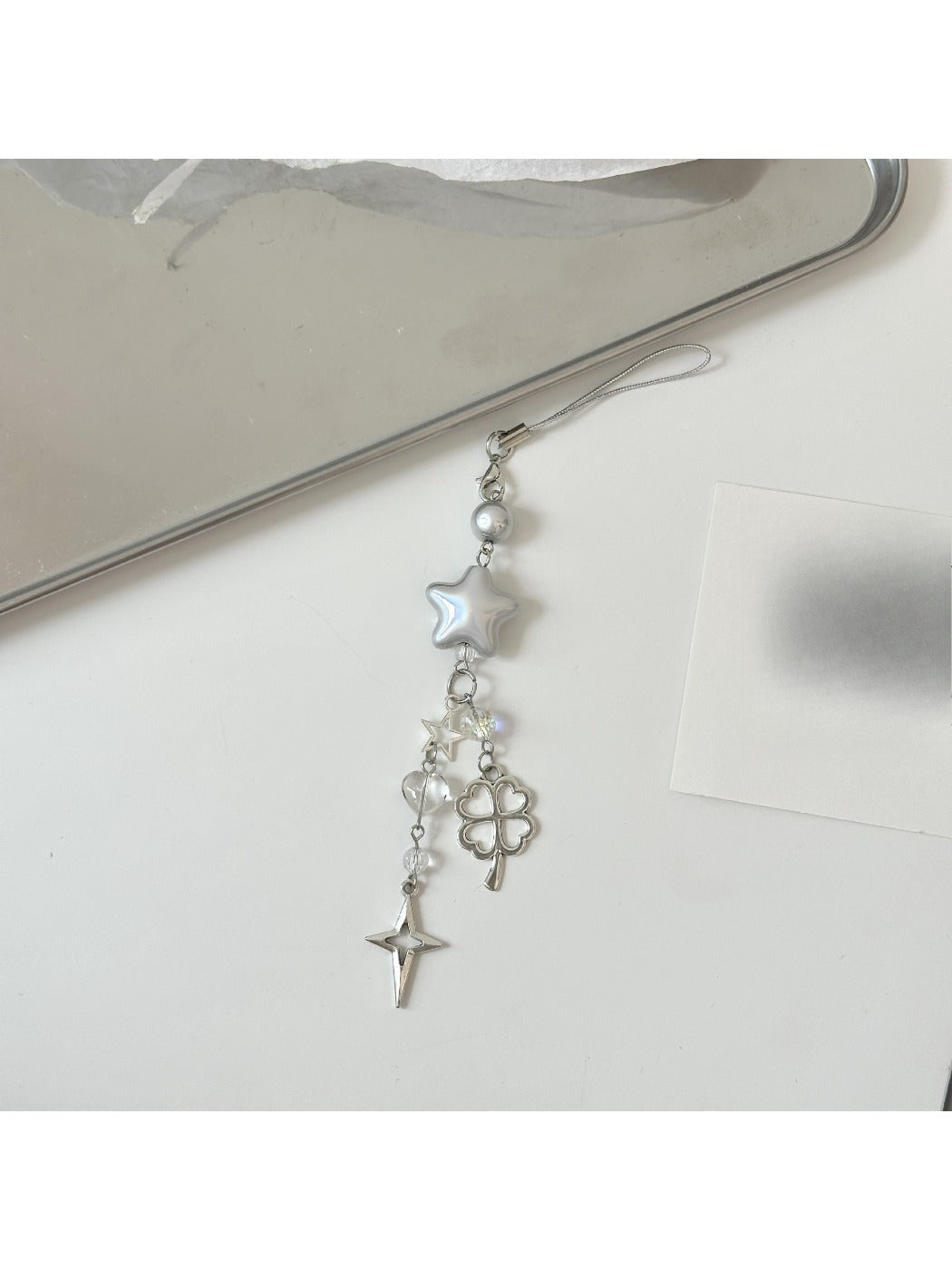 Star keychain displayed on a flat surface highlighting holographic effect