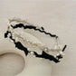 Side view of Gifty Sweet Oval Bead Bow Headband highlighting bead arrangement and bow