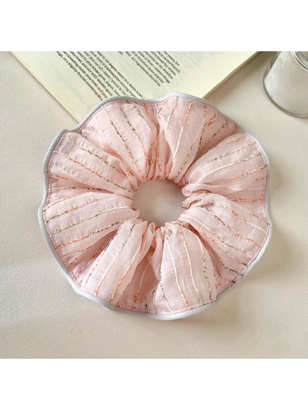 Chic pink striped hair scrunchie on a white background