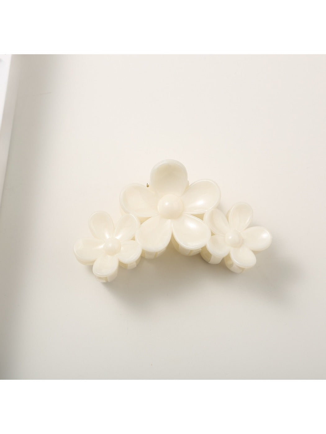 Yellow flower hair clip worn in long brown hair, styled on the side