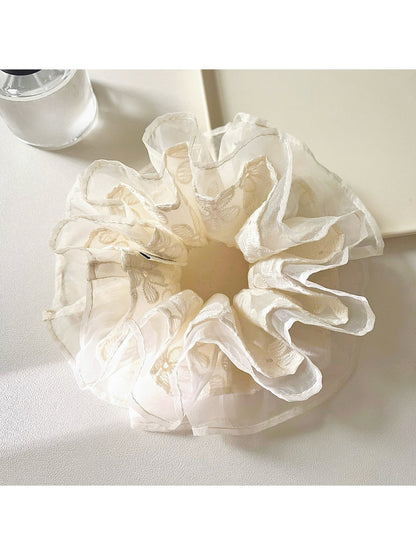 Side view of Gifty embroidered flower scrunchie showing delicate tulle fabric