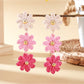Earrings featuring colorful flower design with drop style hooks