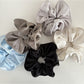 Gifty silky scrunchie displayed on a white background showing smooth satin texture