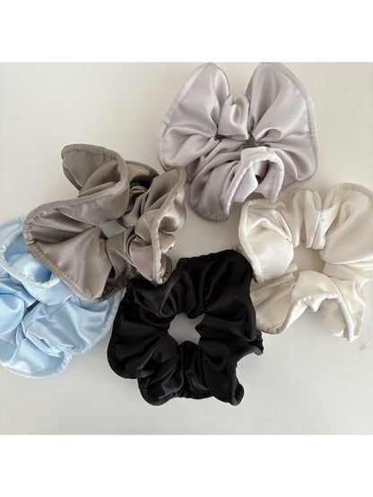 Gifty silky scrunchie displayed on a white background showing smooth satin texture