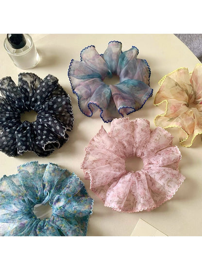 Close-up of Gifty retro style floral scrunchie with pink and green flower pattern