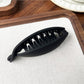 Beau high ponytail hair clip displayed on a wooden surface