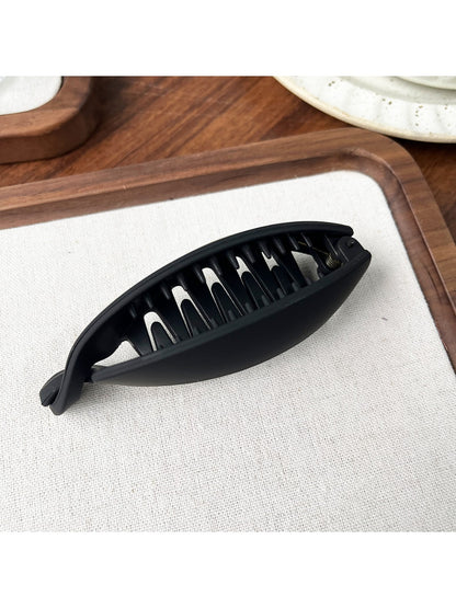 Beau high ponytail hair clip displayed on a wooden surface