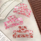 Beau hair claw clip held in hand displaying size and openwork pattern