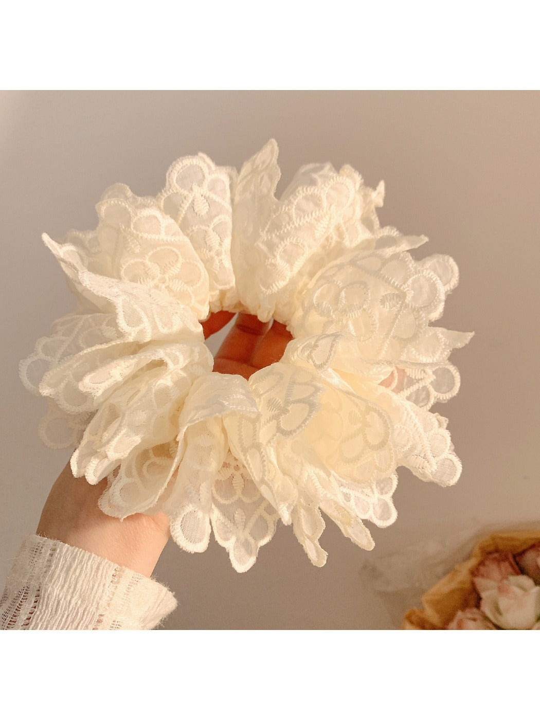 White double layer scrunchie worn in a ponytail on a model with dark hair