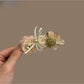 Beau 3D flower shaped hair clip in soft pink on white background