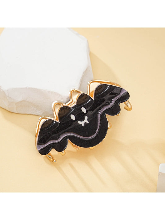 Black bat shaped hair clip with detailed wings on a white background