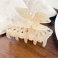 Beau butterfly hair claw clip with open clasp showing spring mechanism