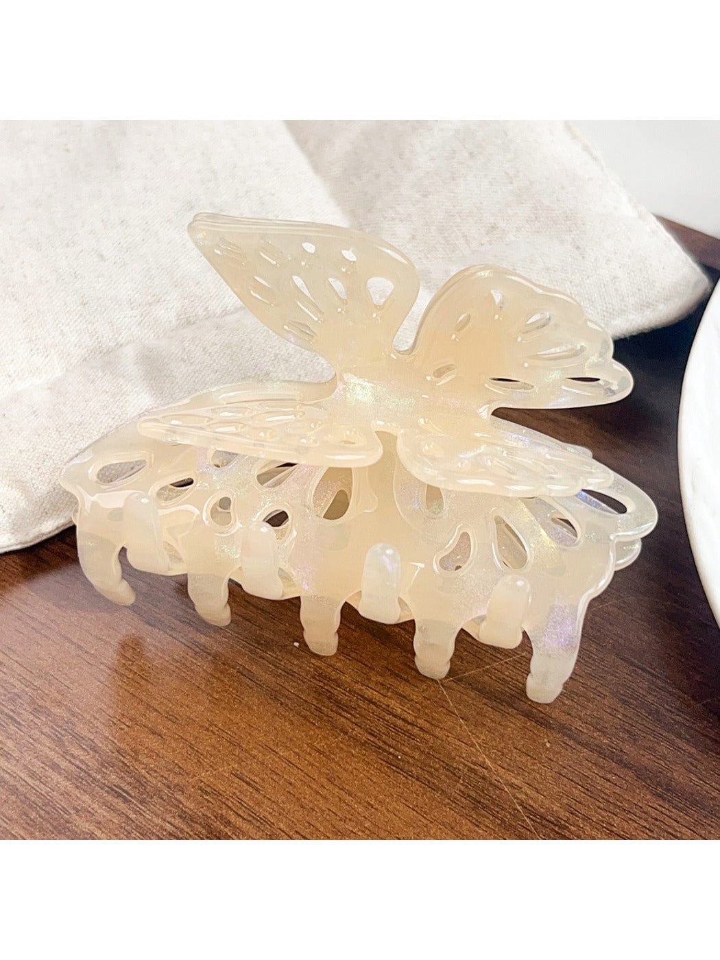 Beau butterfly hair claw clip with open clasp showing spring mechanism