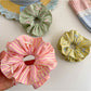 Gifty scrunchie stretched to display elastic band inside
