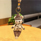 Side view of the bear keychain showing detailed hat and facial features