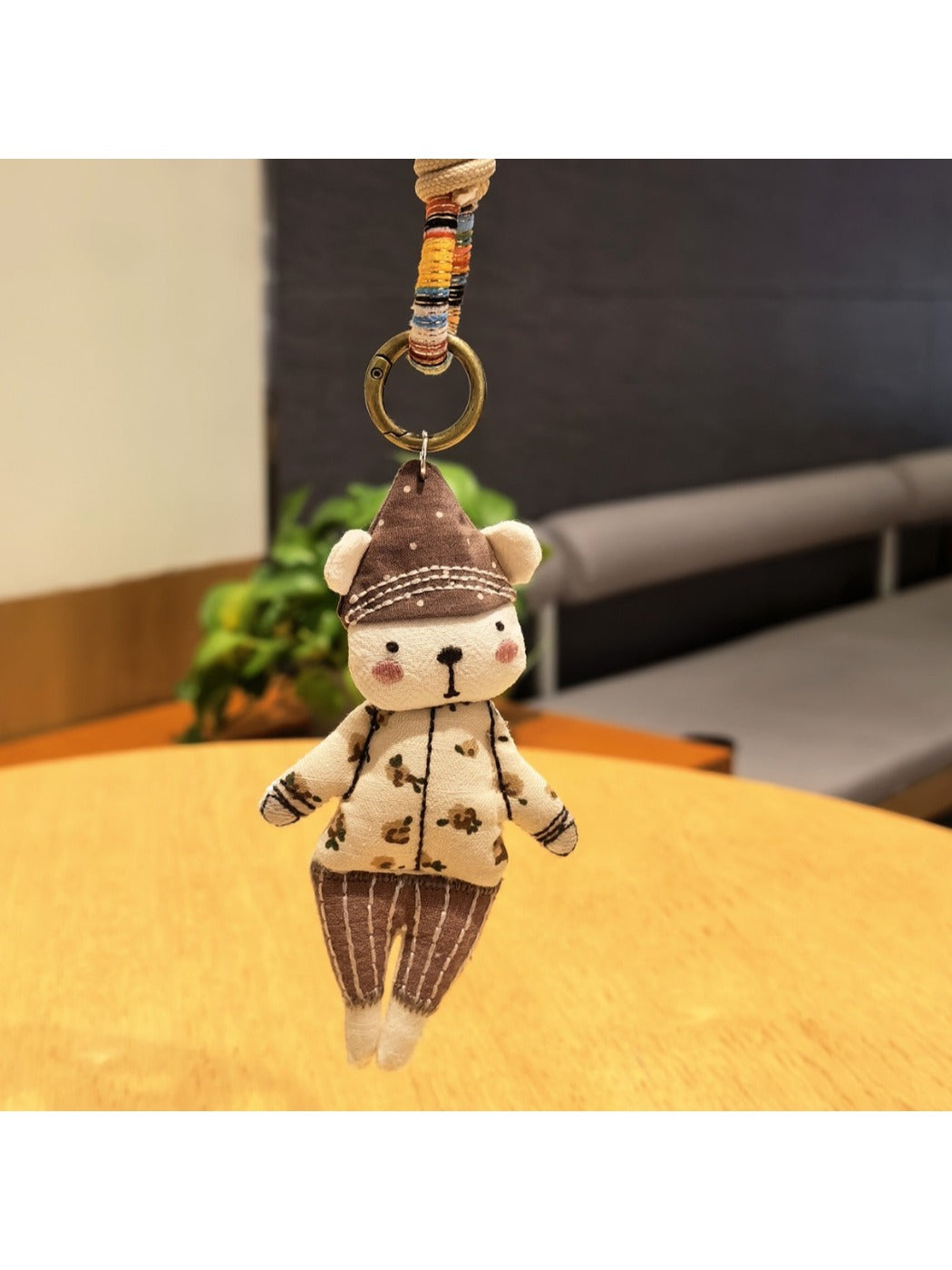 Side view of the bear keychain showing detailed hat and facial features