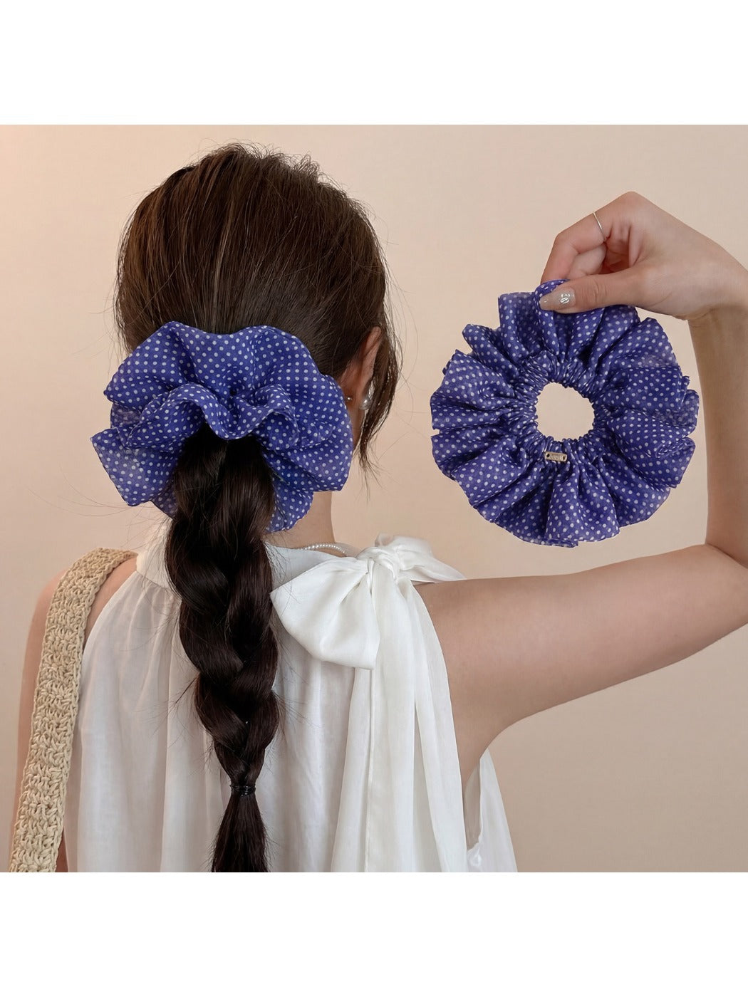 Side view of ruffled scrunchie showing fabric texture and polka dot pattern