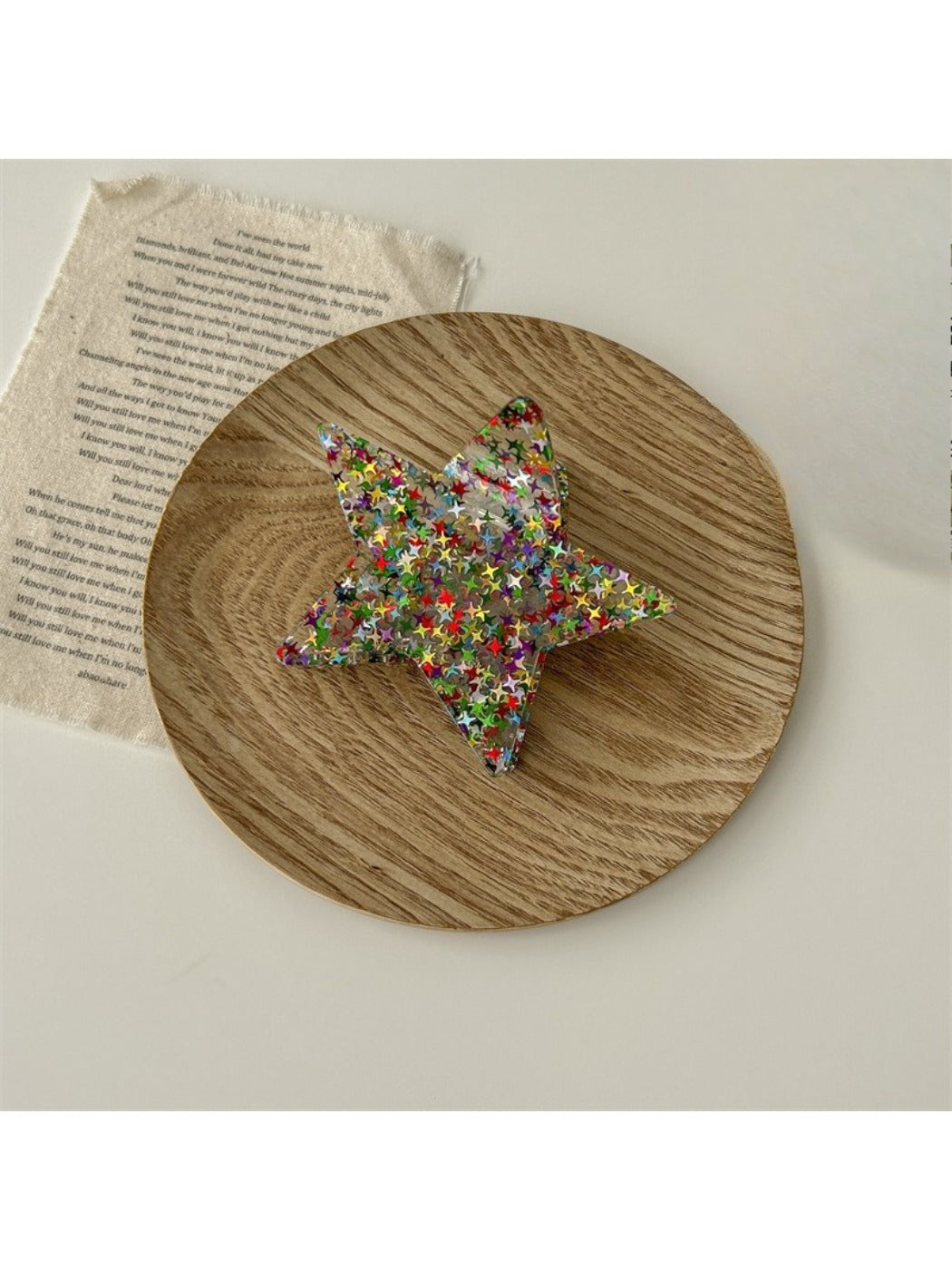 Beau star shaped claw clip on white background, angled view