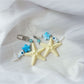 Starfish keychain hanging from a bag zipper, demonstrating practical use