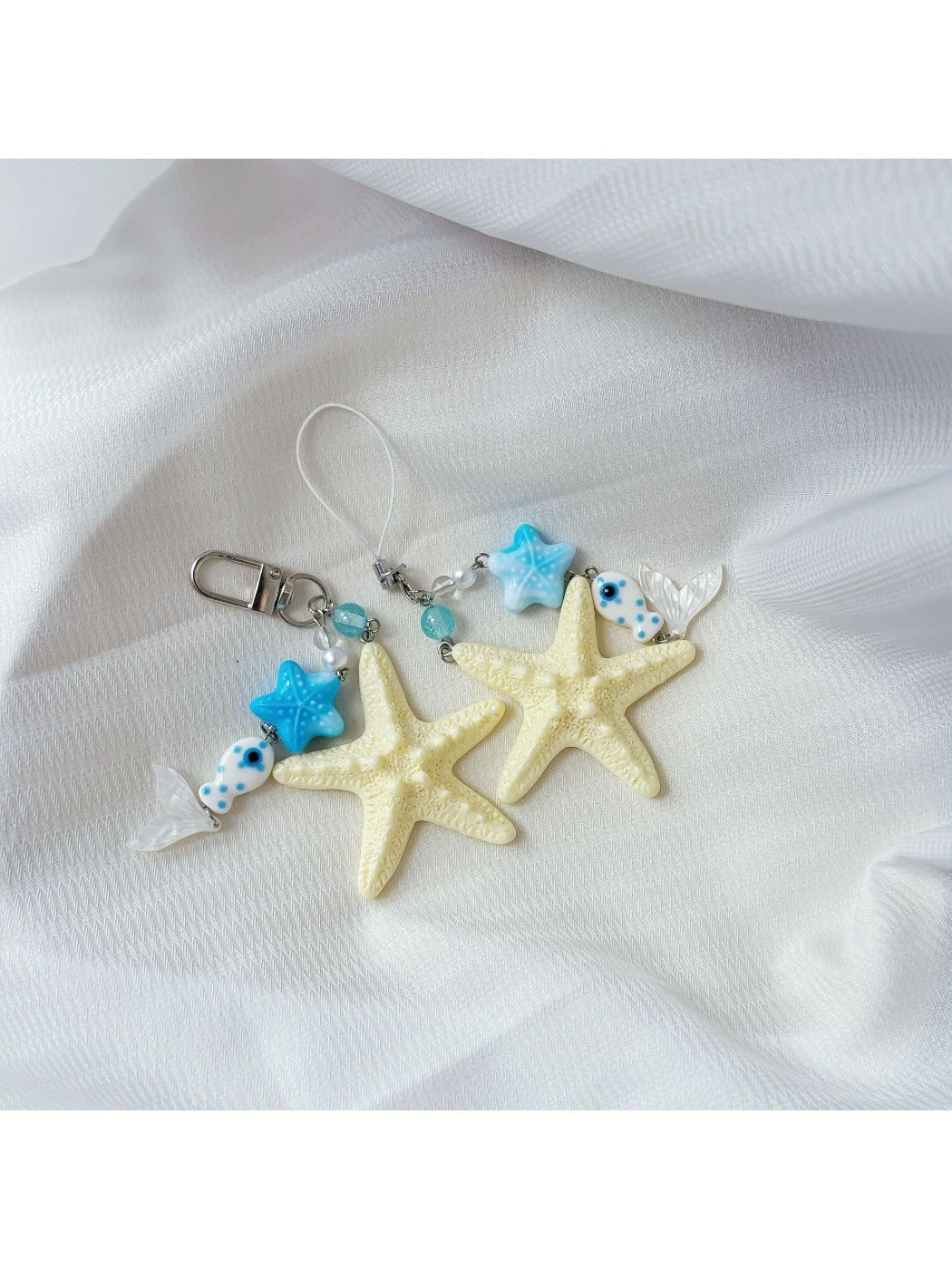 Starfish keychain hanging from a bag zipper, demonstrating practical use