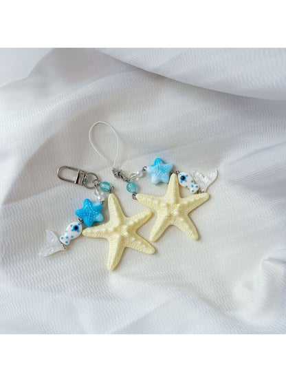 Starfish keychain hanging from a bag zipper, demonstrating practical use