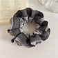 Side view of Gifty satin and tulle patchwork scrunchie