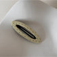 Beau polka dot hair clip shown from above highlighting shape and pattern
