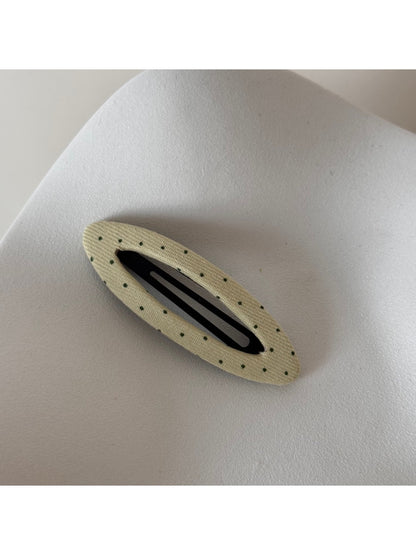 Beau polka dot hair clip shown from above highlighting shape and pattern