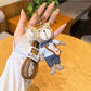 Close-up of a trendy bear charm keychain with a gold ring and brown bear figure