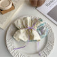 Gifty scrunchie headband and hair clip displayed together on a flat surface