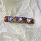 Blue and green square hair clips shown from side angle highlighting thickness