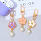Close-up of the flower charm showing detailed colorful petals and silver keyring