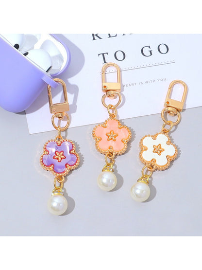Close-up of the flower charm showing detailed colorful petals and silver keyring