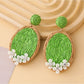 Earedge raffia woven oval earrings photographed with natural lighting