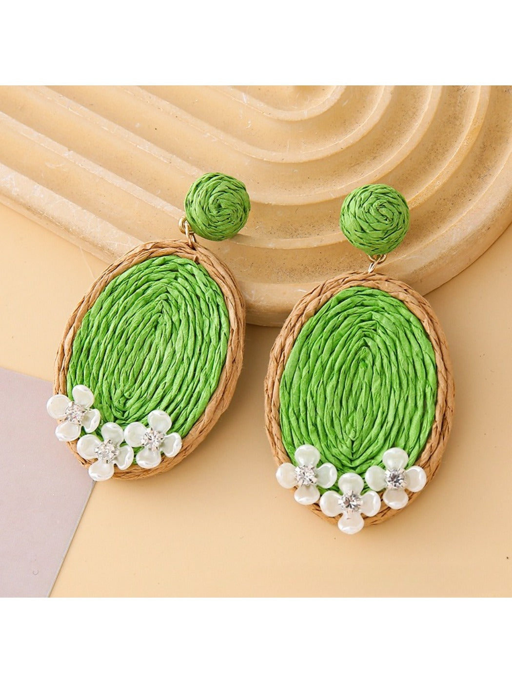 Earedge raffia woven oval earrings photographed with natural lighting