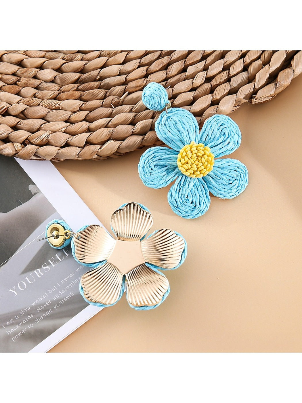 Earedge flower shaped drop earrings displayed on a wooden surface