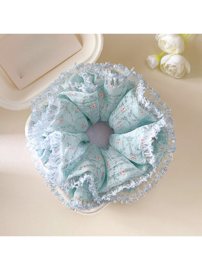 Close-up of lake blue floral scrunchie showing fabric texture and layers