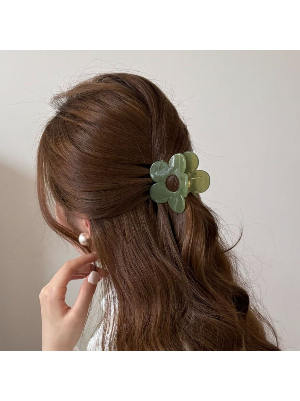 Beau mini flower claw clip holding a small section of hair