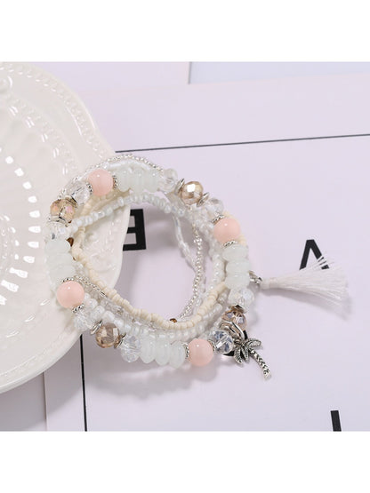 Lovra boho tassel bracelet wrapped around a wrist with natural skin tone