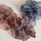 Pink sparkly tulle scrunchie styled on a wrist as a bracelet
