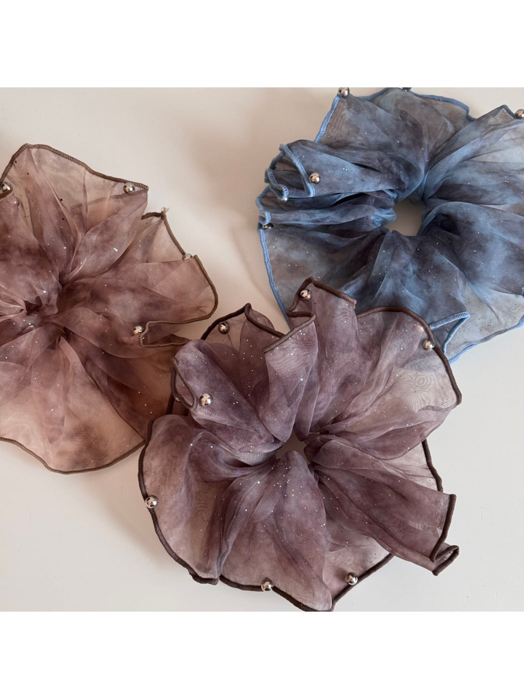 Pink sparkly tulle scrunchie styled on a wrist as a bracelet